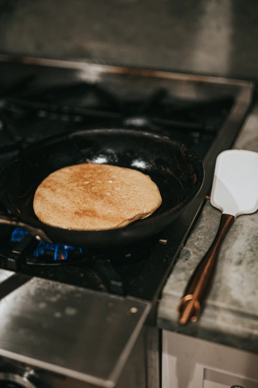 a frying pan with a small cast iron set cooking on top of it