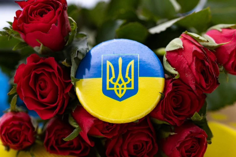 a russian flag on sitting on top of some red roses