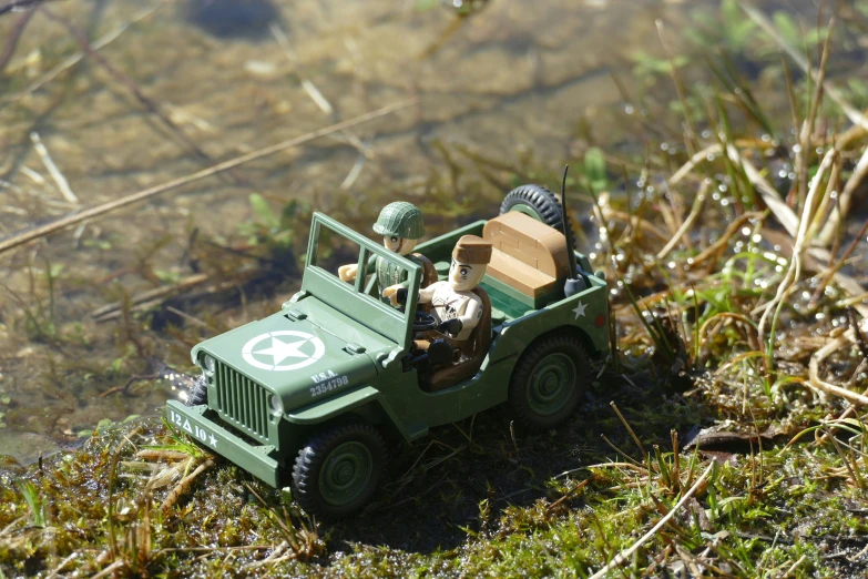 an army jeep with two people in it's cab