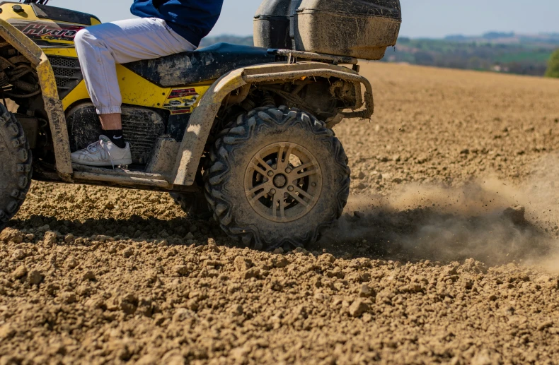 person riding on atv in the middle of a field