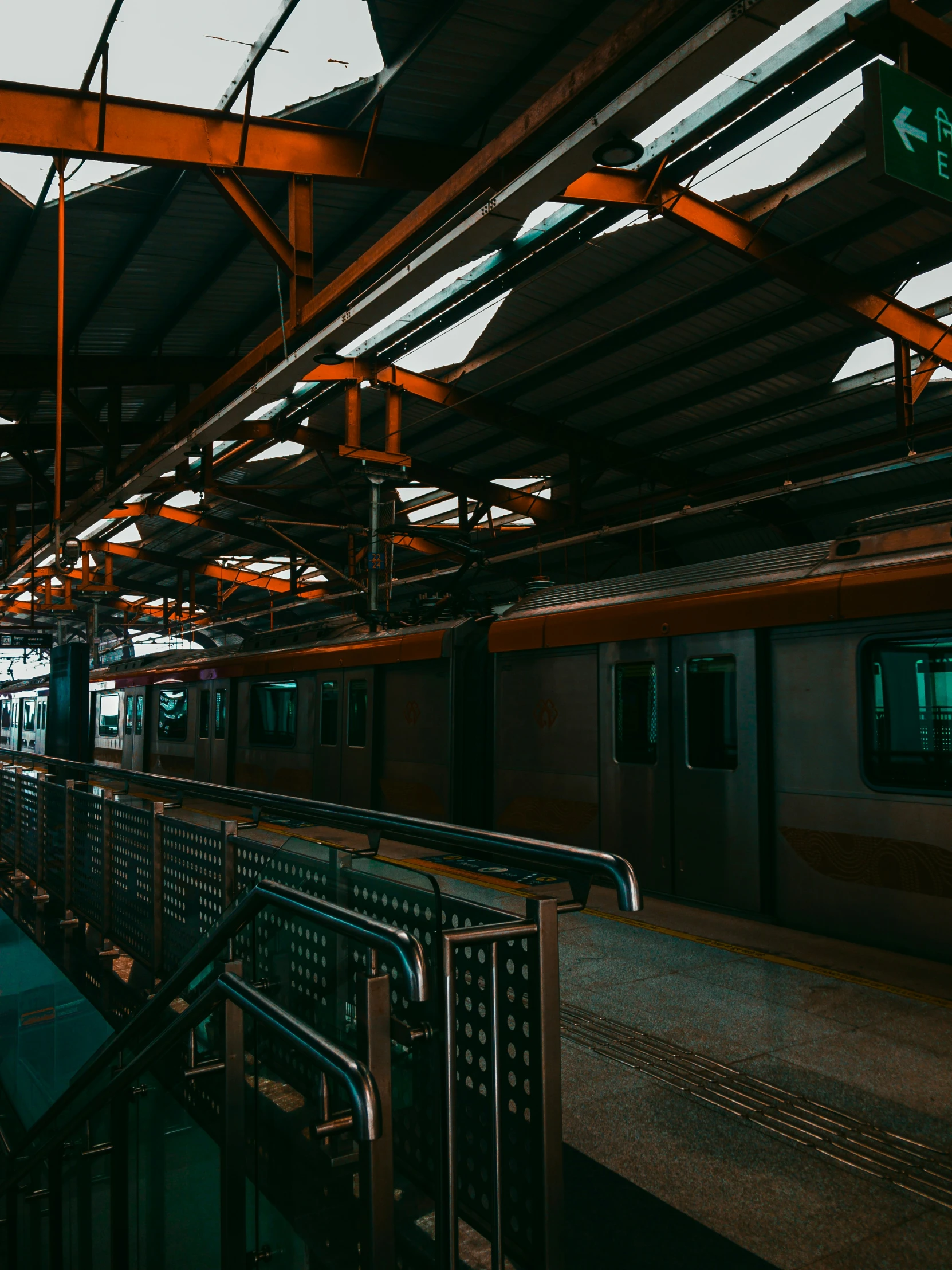 two train carts sitting in the middle of a train station