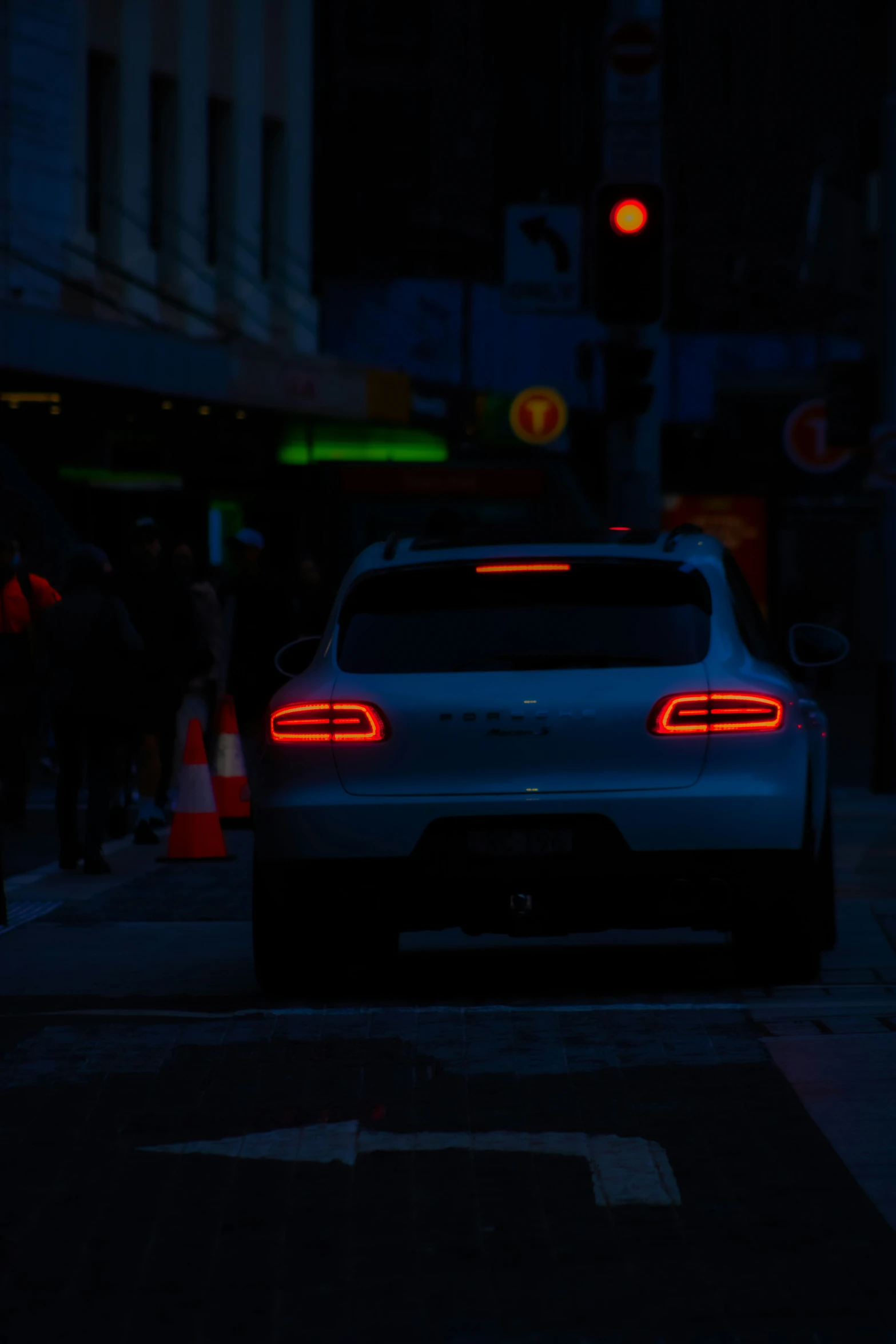 a rear view of a car on the street at night