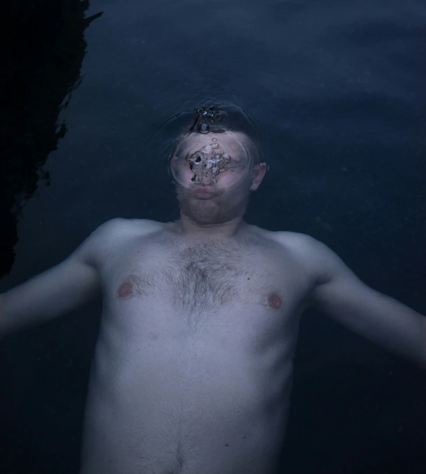 the man is posing in the water for a po