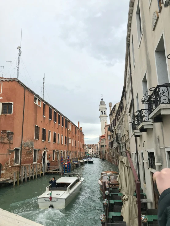 a waterway with many boats passing by some buildings