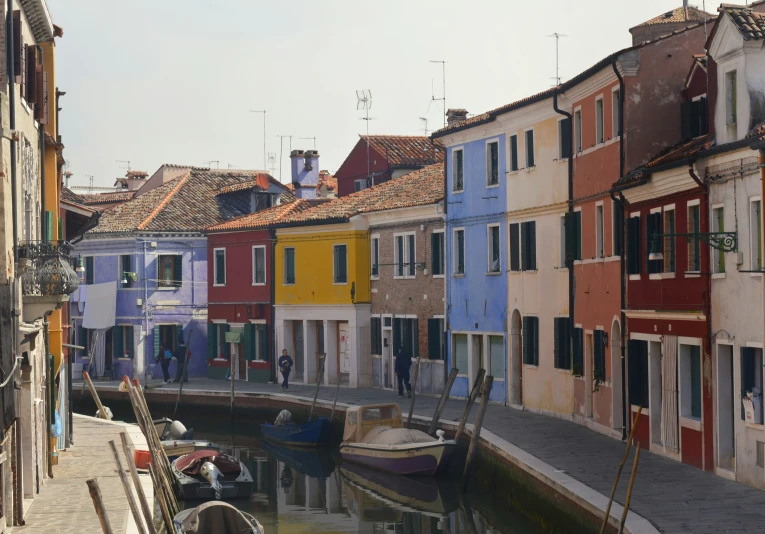 some buildings on the side of water and boats