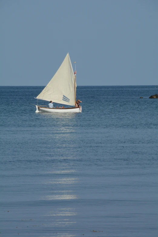 a sailboat that is floating on the ocean