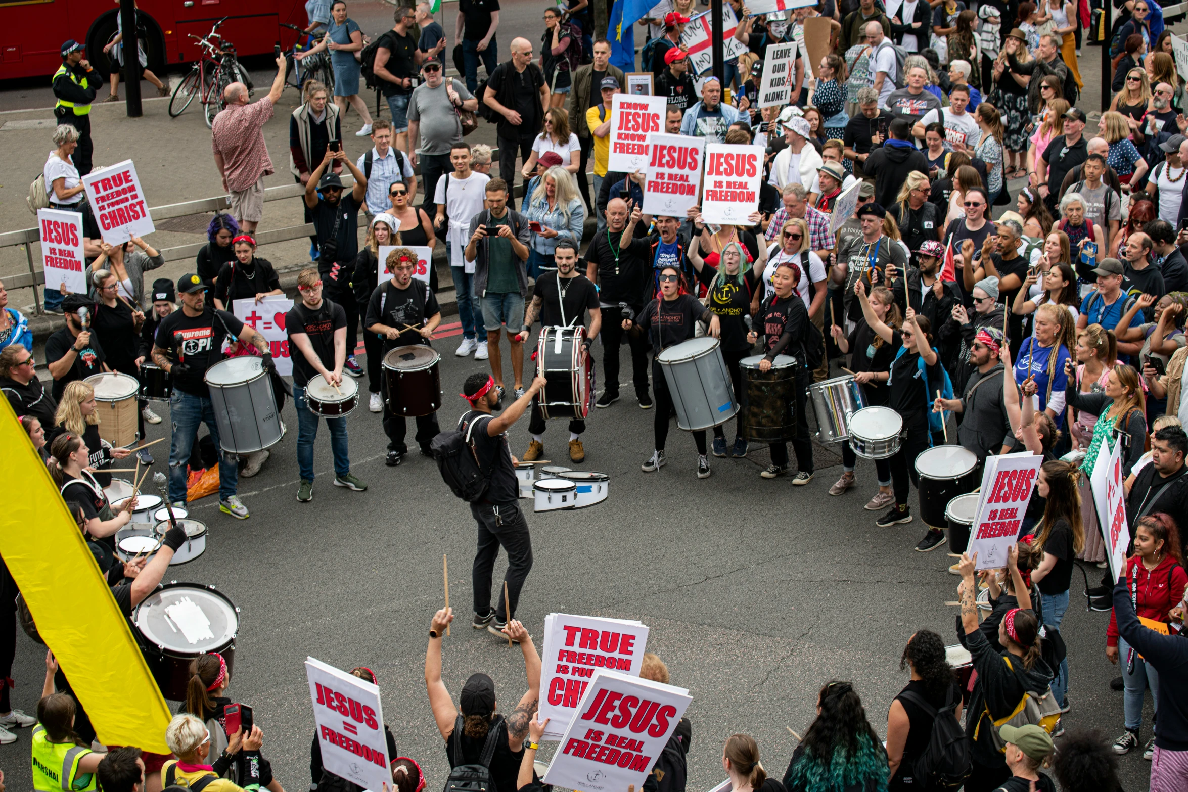 group of protesters with drums and sign march