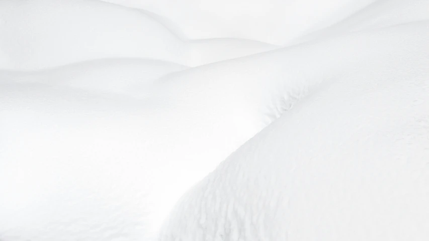 there is a snow covered bed and white sheets