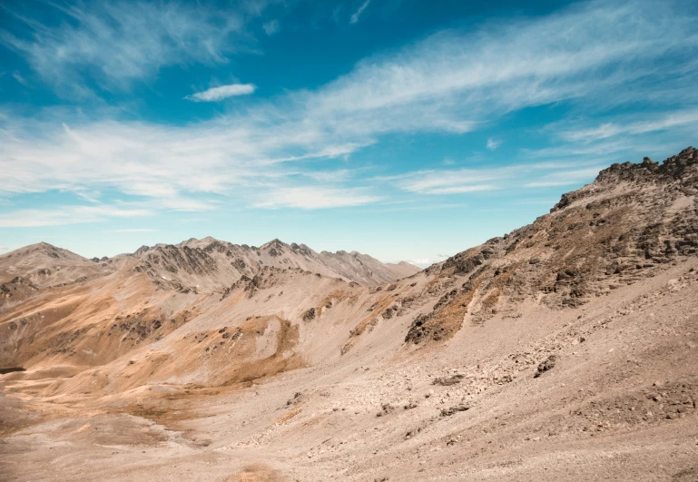 a person hiking across a barren area in the desert