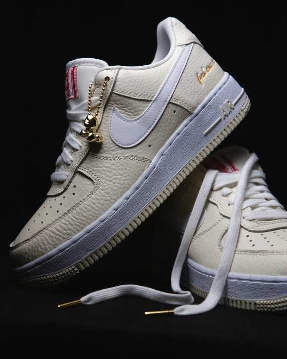 a pair of white shoes with gold zippers on them