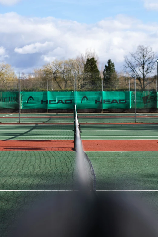 two men playing tennis on a green court