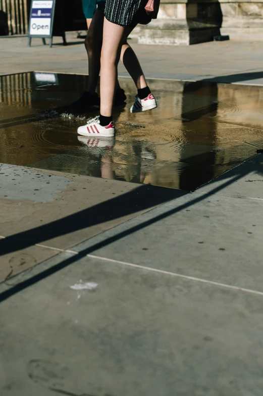 a person walking in the rain under an umbrella