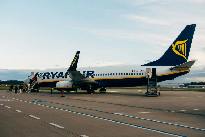 large jet liners and ladders with people boarding it