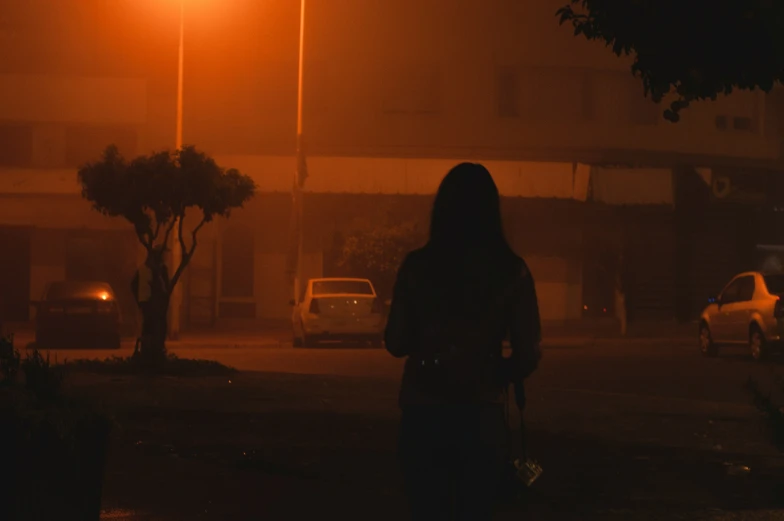 person walking down a street at night time