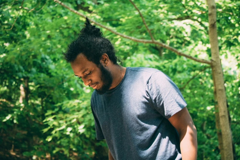 a man standing in the woods holding onto his cell phone