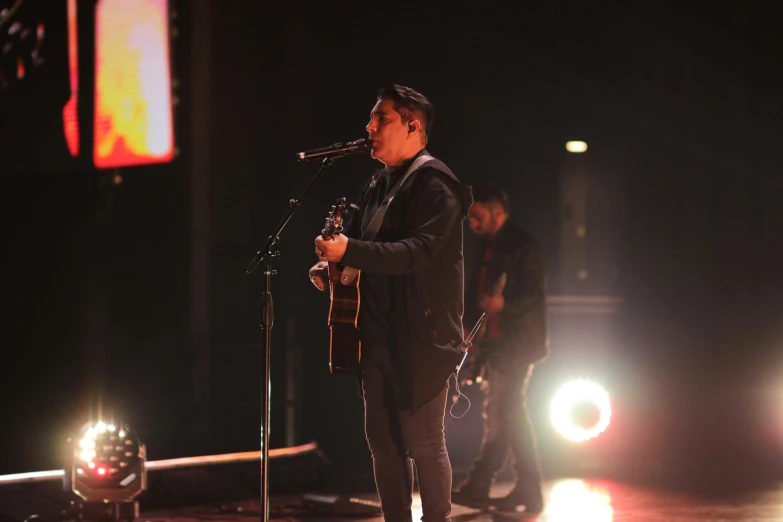 a man standing on stage with a microphone