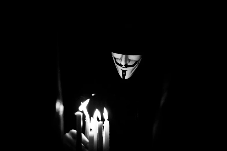 a man with a mask and some candles