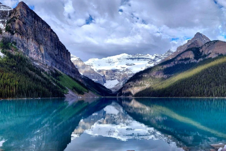 mountains and trees surrounding a large lake with many water