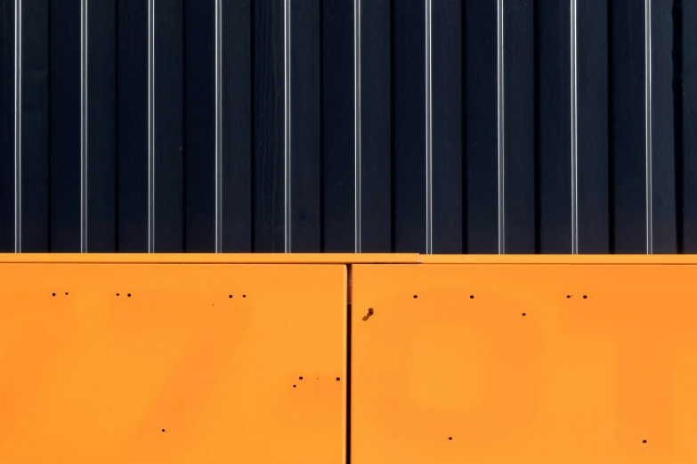 an orange building with steel and black siding