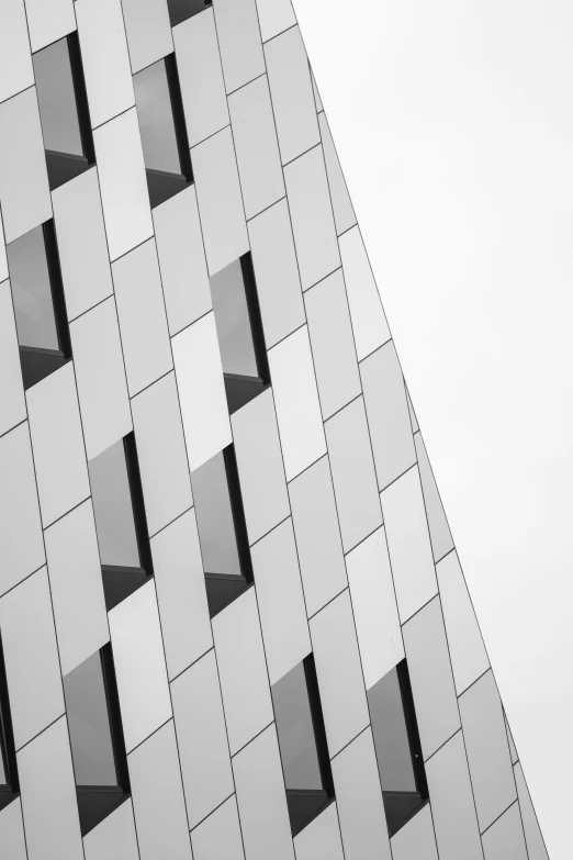 the top part of an office building with windows in the wall