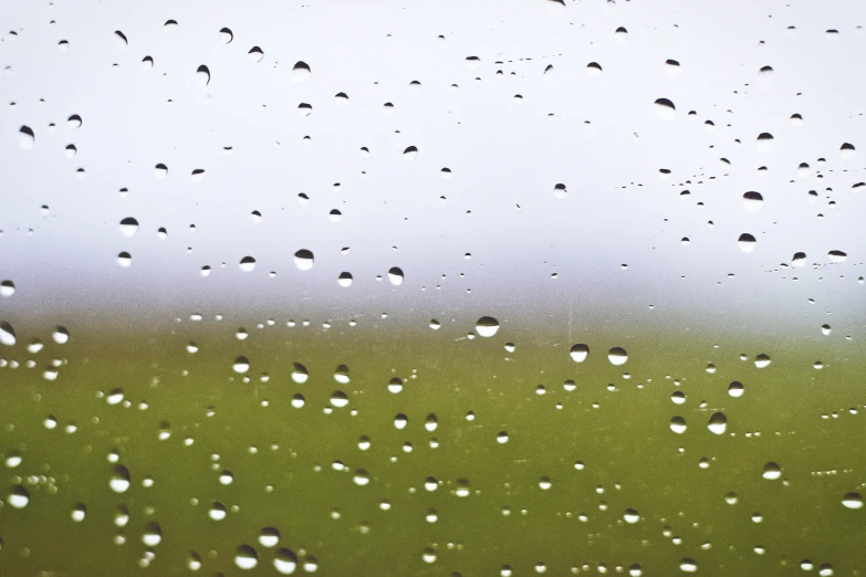 rain drops running from the top of a window