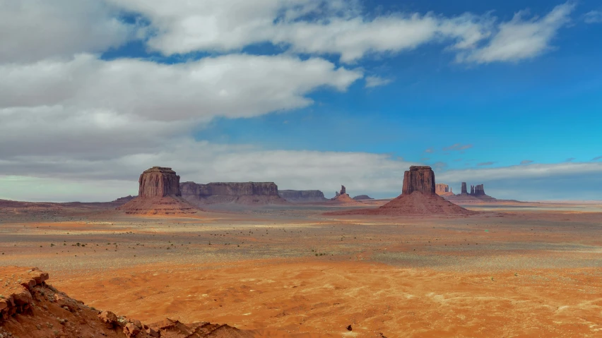 two large rocks with sp vegetation on the foreground