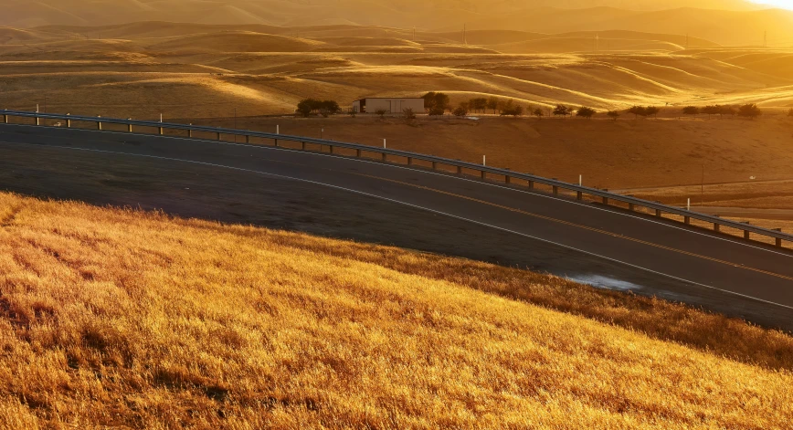 a car is on a winding road in the countryside