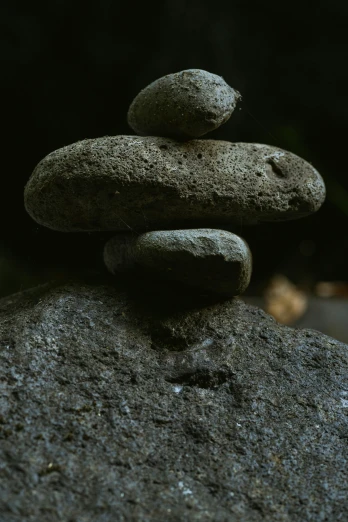 a stack of rocks sitting on top of a gray rock