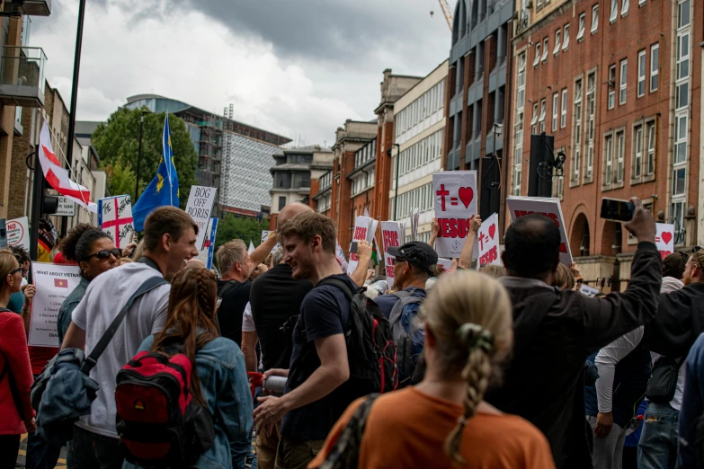 large crowd of people standing outside on the street