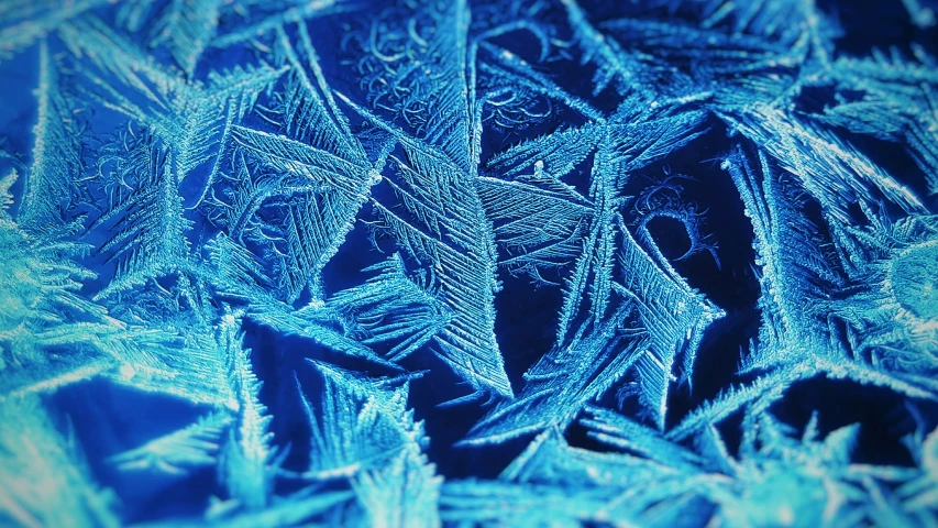 this blue frost - covered window looks like it has a light shiner