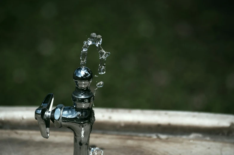 a close up of a faucet with water in it