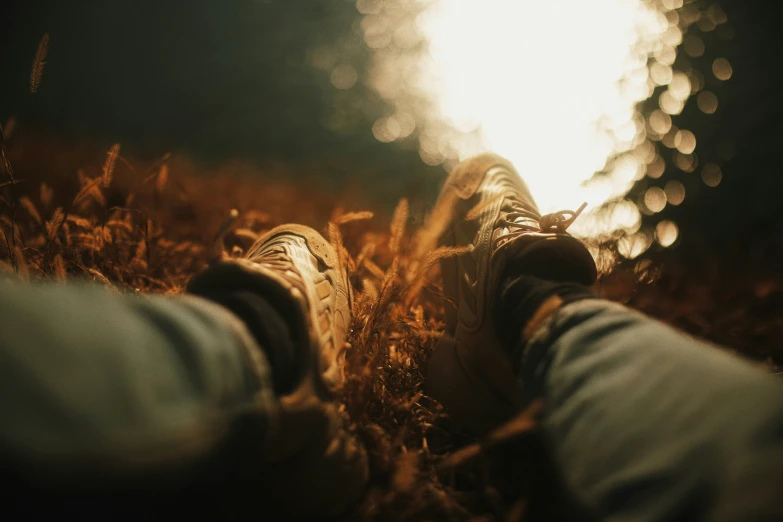 the feet of someone who is walking on grass