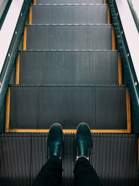 a person standing on some stairs with their legs in the air