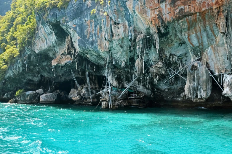 a boat sits in the water near an island