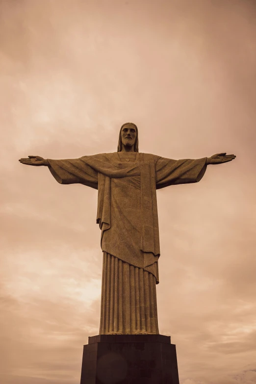 a large statue that looks like christ is holding his arms out