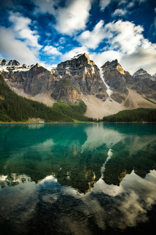 some water with rocks some clouds and mountains