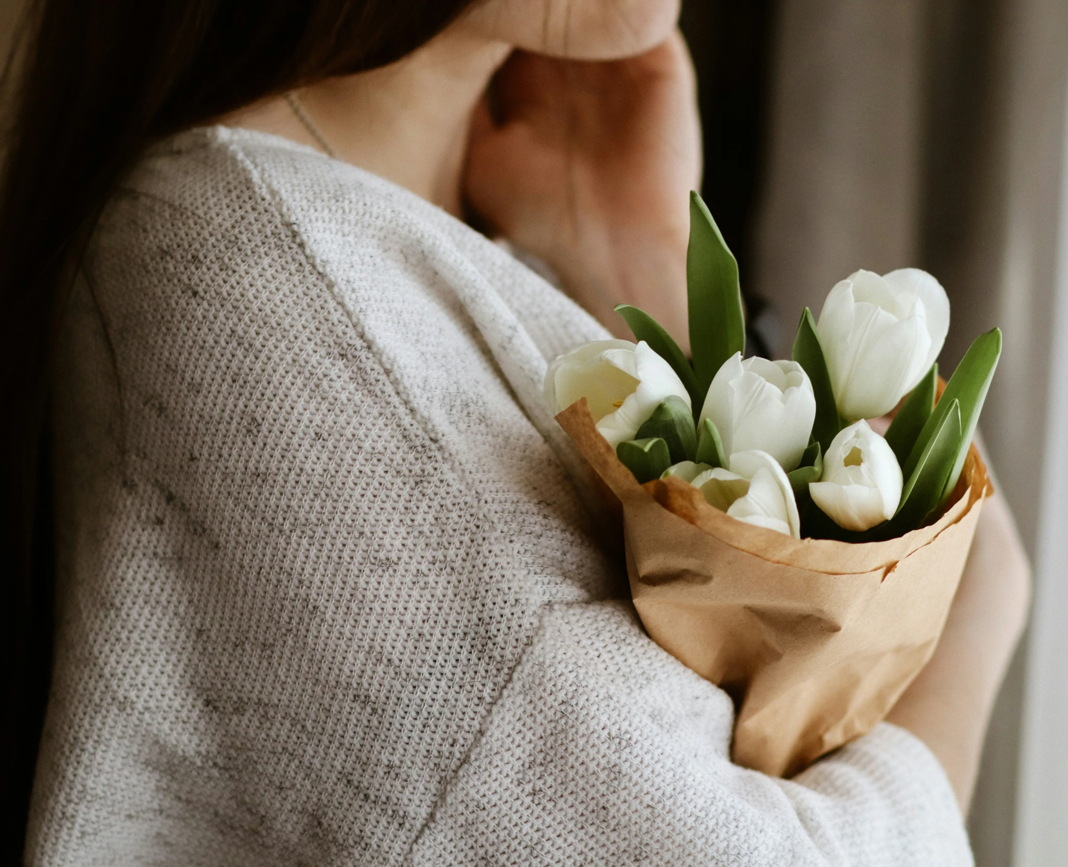 a close up of a woman holding flowers