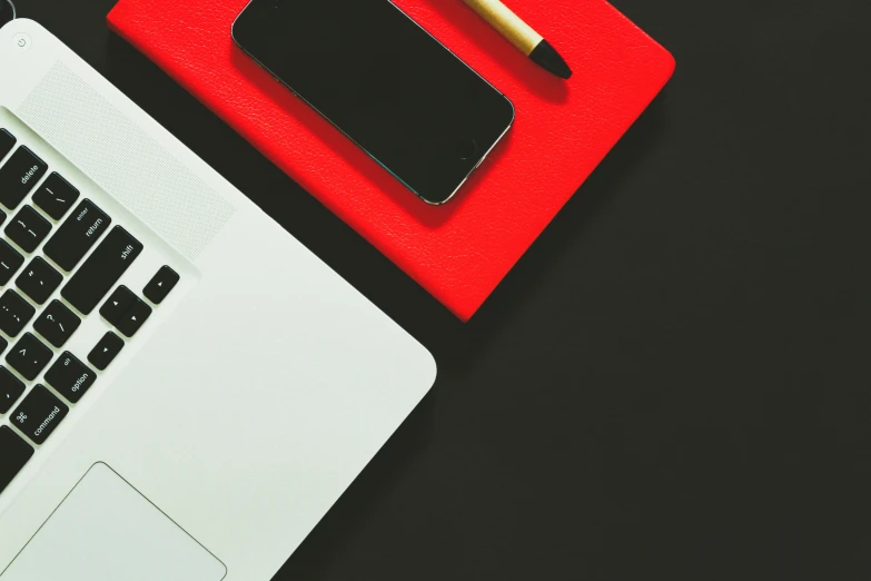 a keyboard, mouse and cup on a desk