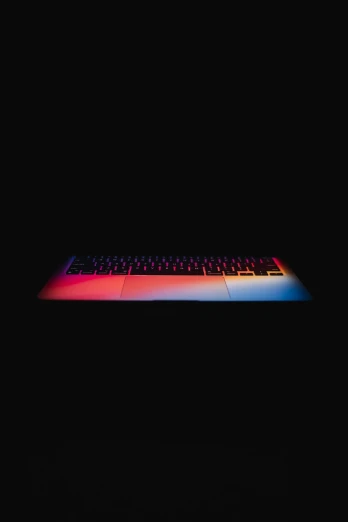 there is a computer keyboard that is on the black background