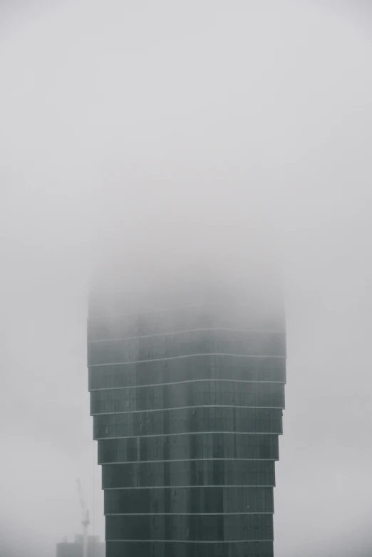 buildings are standing together in the distance behind heavy clouds