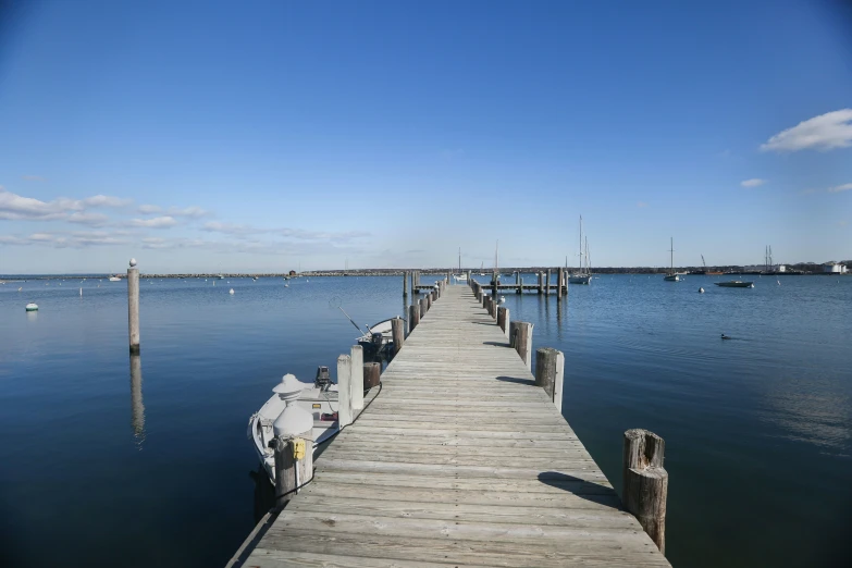 a pier with several boats in the water