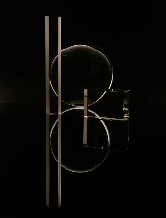 a black table with three round glass shelves