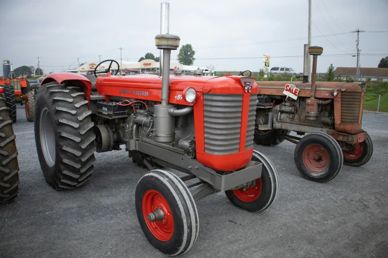 an old farm tractor that has been painted orange