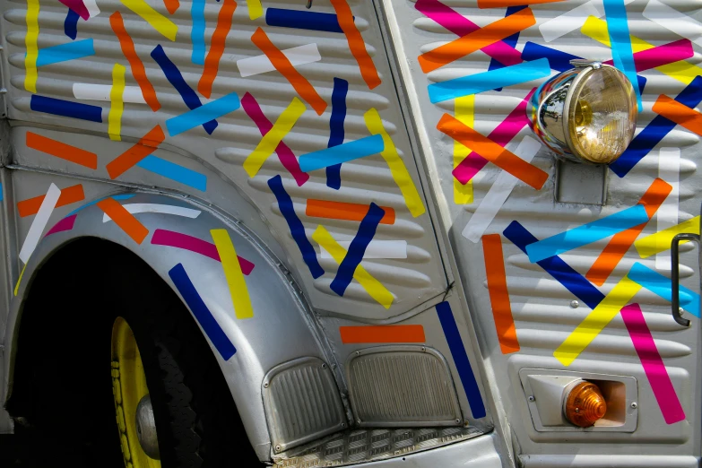 an art truck that has paint all over the side