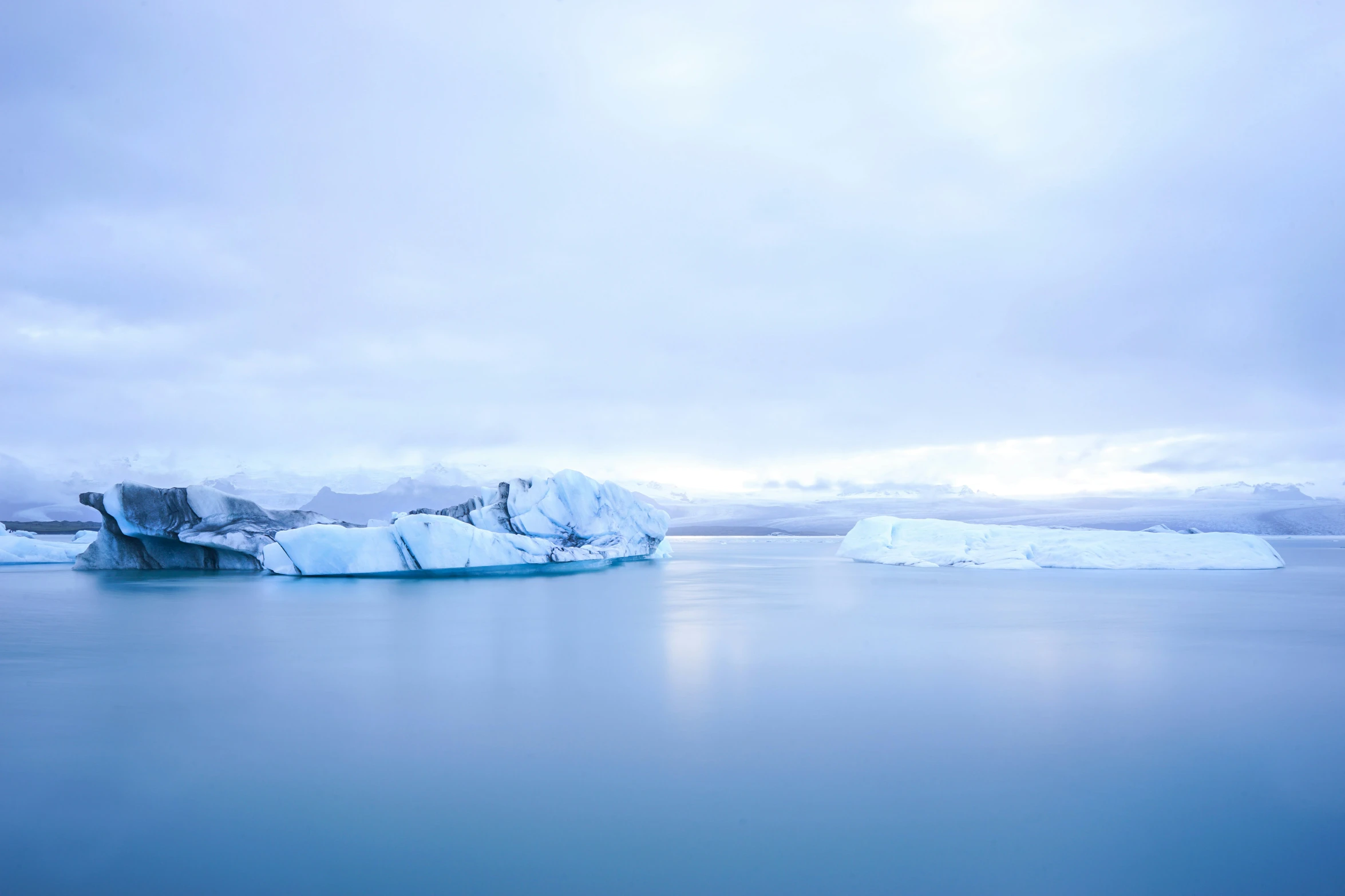 a very big iceberg floating in the middle of some water