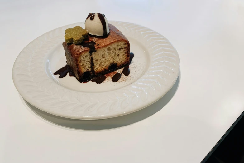 a slice of cake on a plate with ice cream and chocolate