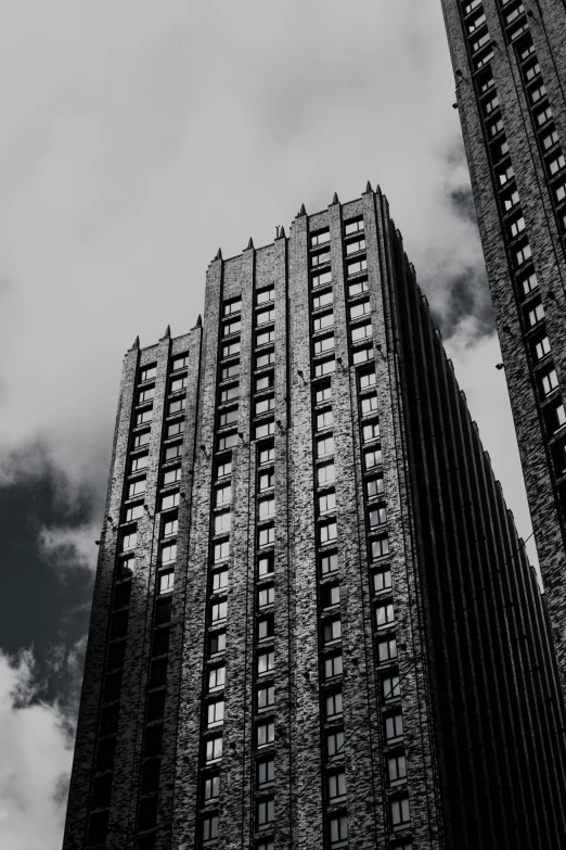 a tall building in the distance is standing up with the clouds flying