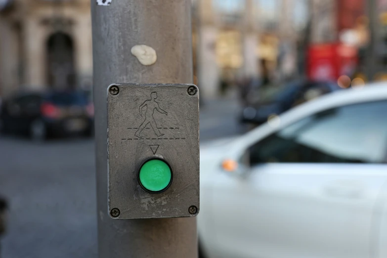 the sign is on a metal pole near a street