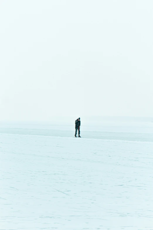 a couple standing on the snow looking at soing