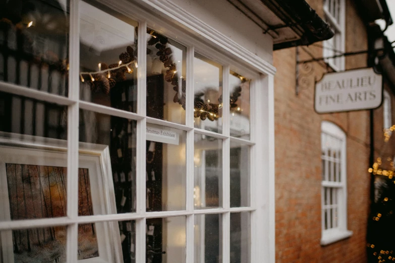 an old fashioned store with vintage books on the windows